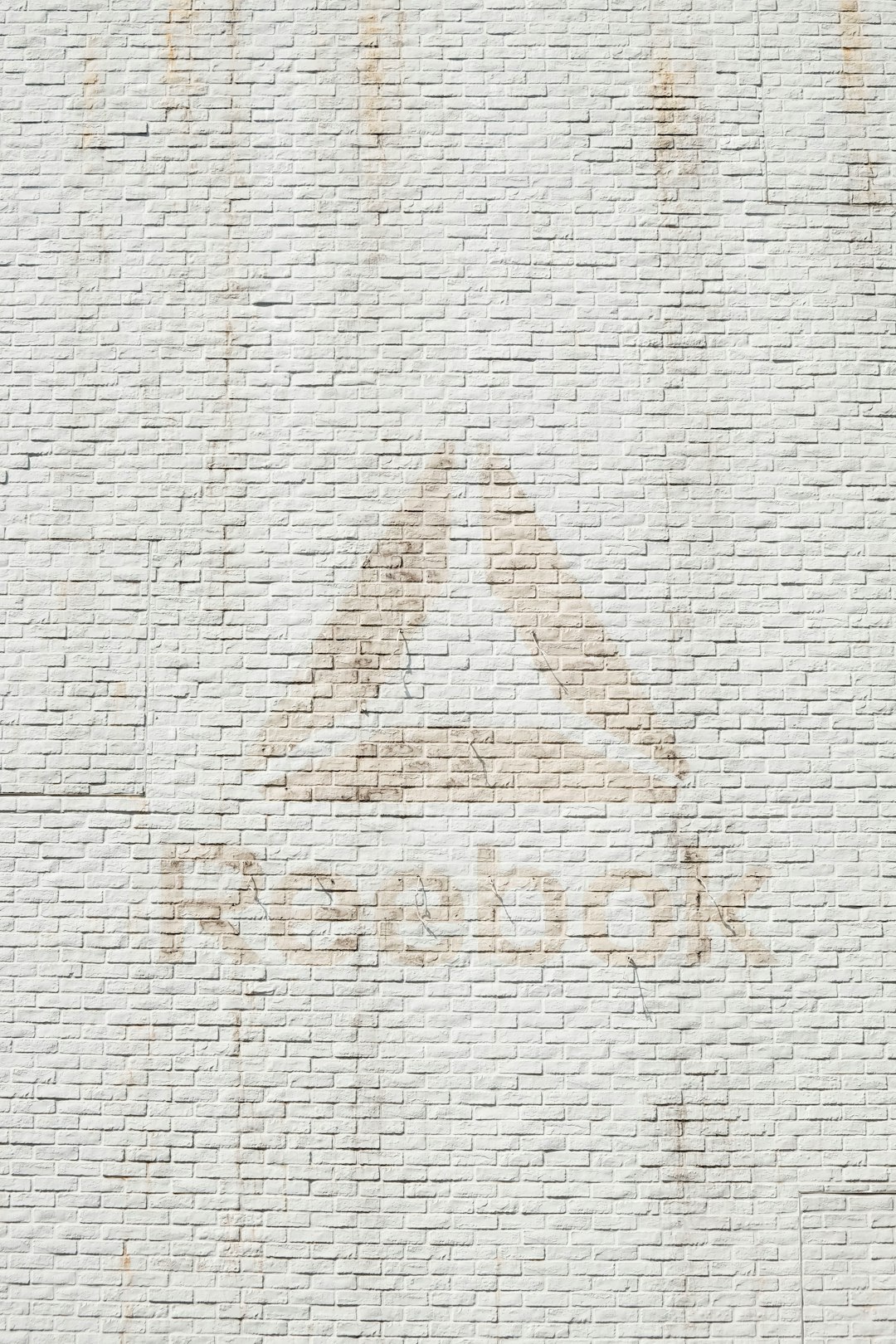 close-up photo of Reebok logo on wall