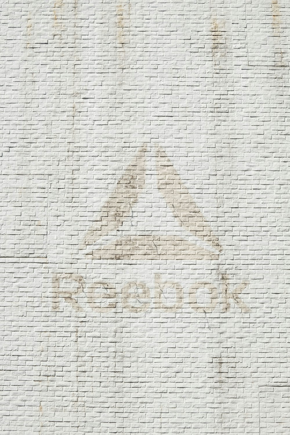 close-up photo of Reebok logo on wall