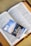 An open book with text in the English language, possibly a religious scripture, has a booklet placed on top of it. The booklet has an image of a scenic landscape and the words 'Talking with God' printed on the cover.