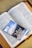 An open book with text in the English language, possibly a religious scripture, has a booklet placed on top of it. The booklet has an image of a scenic landscape and the words 'Talking with God' printed on the cover.