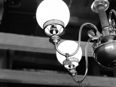 Close-up of a handcrafted vintage light fixture with delicate white details.