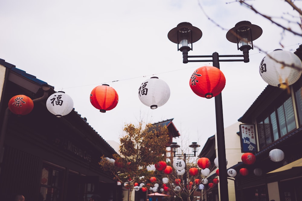 black street light beside lanterns