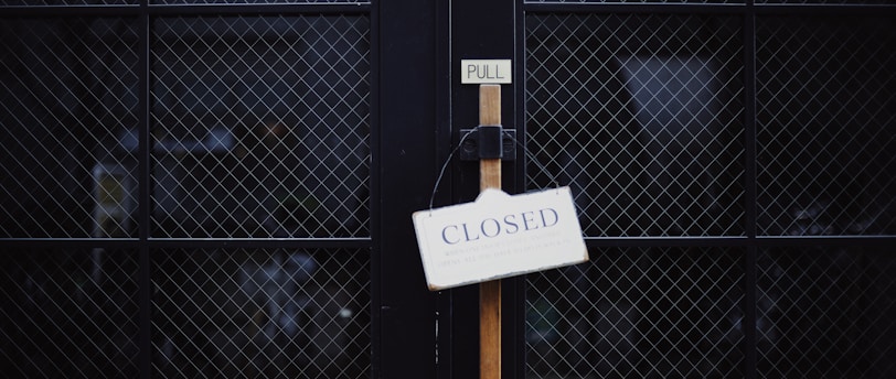 black metal gate with closed signage