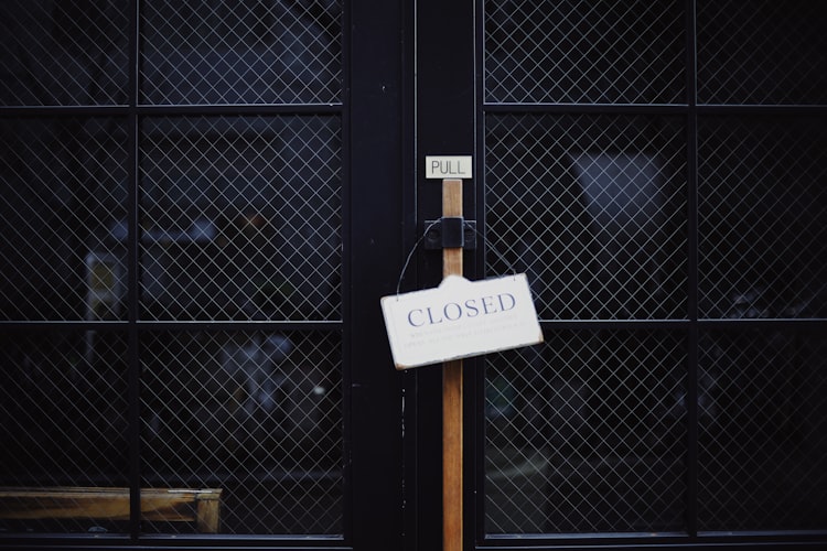 a closed sign on a black door