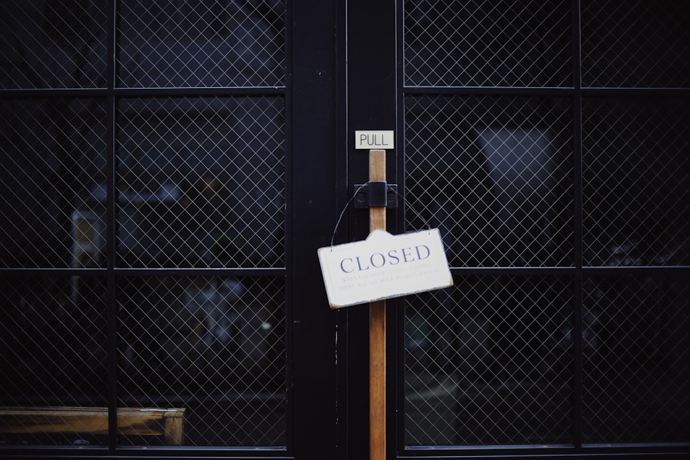 black metal gate with closed signage