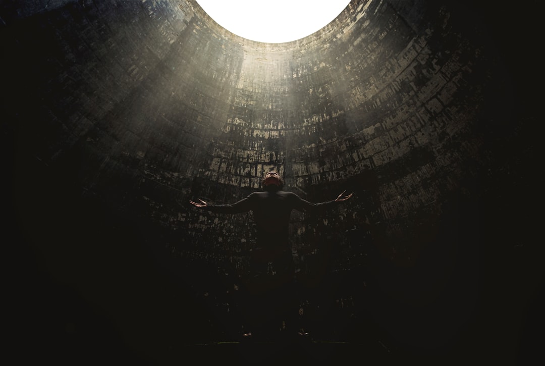 man standing under hole