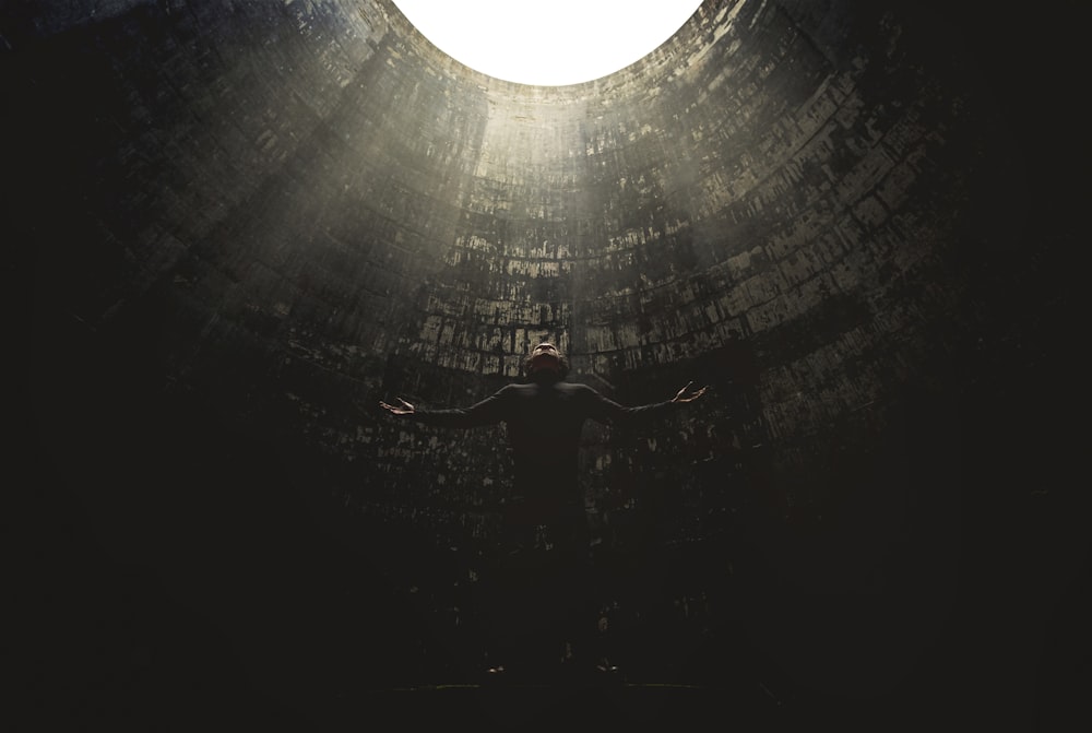 man standing under hole