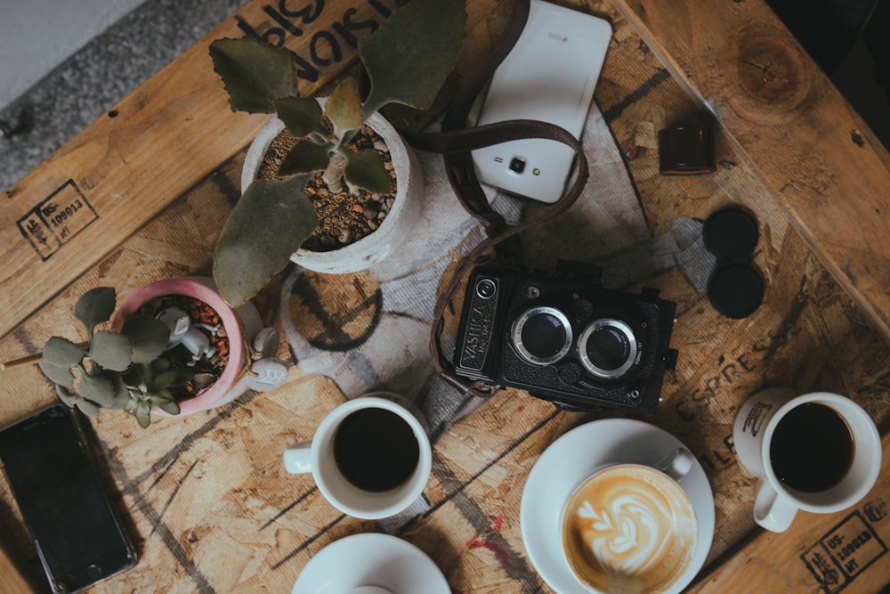 flat lay photo of coffee and camera