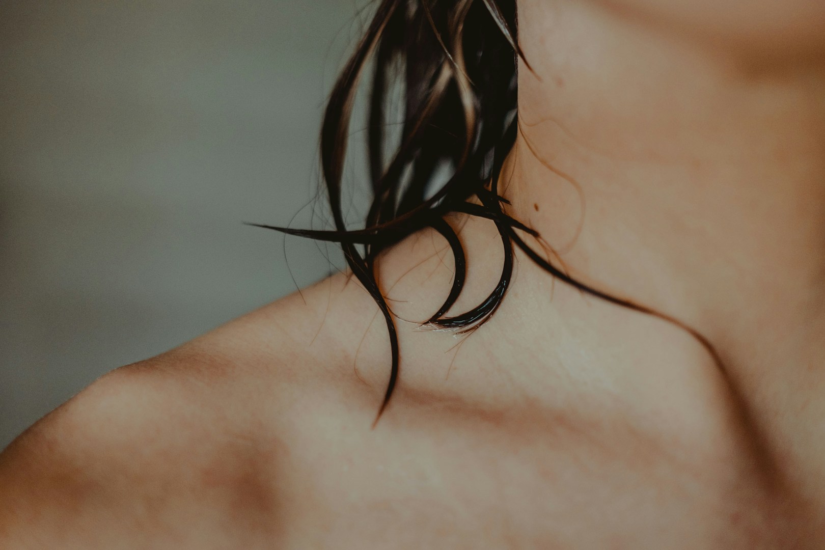 woman's neck and collarbone with wet hair