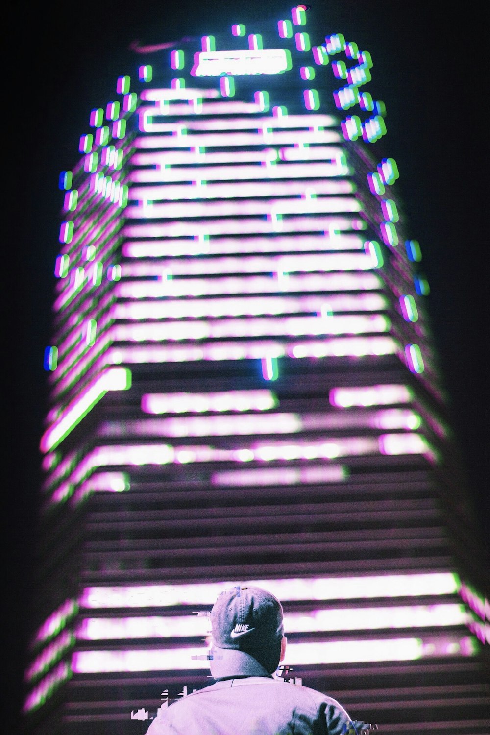 man looking at high-rise building