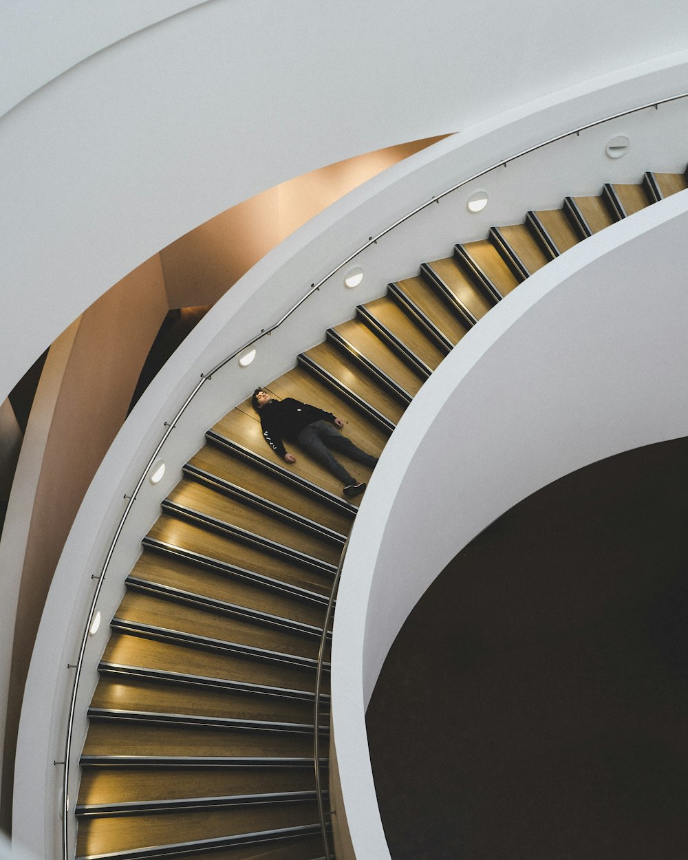 man laying on staircase