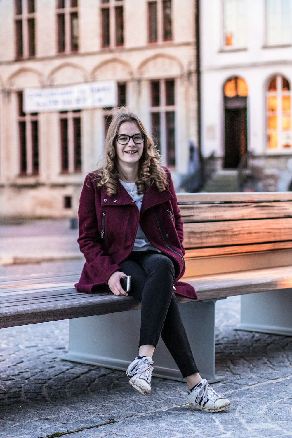 smiling woman sitting on bench