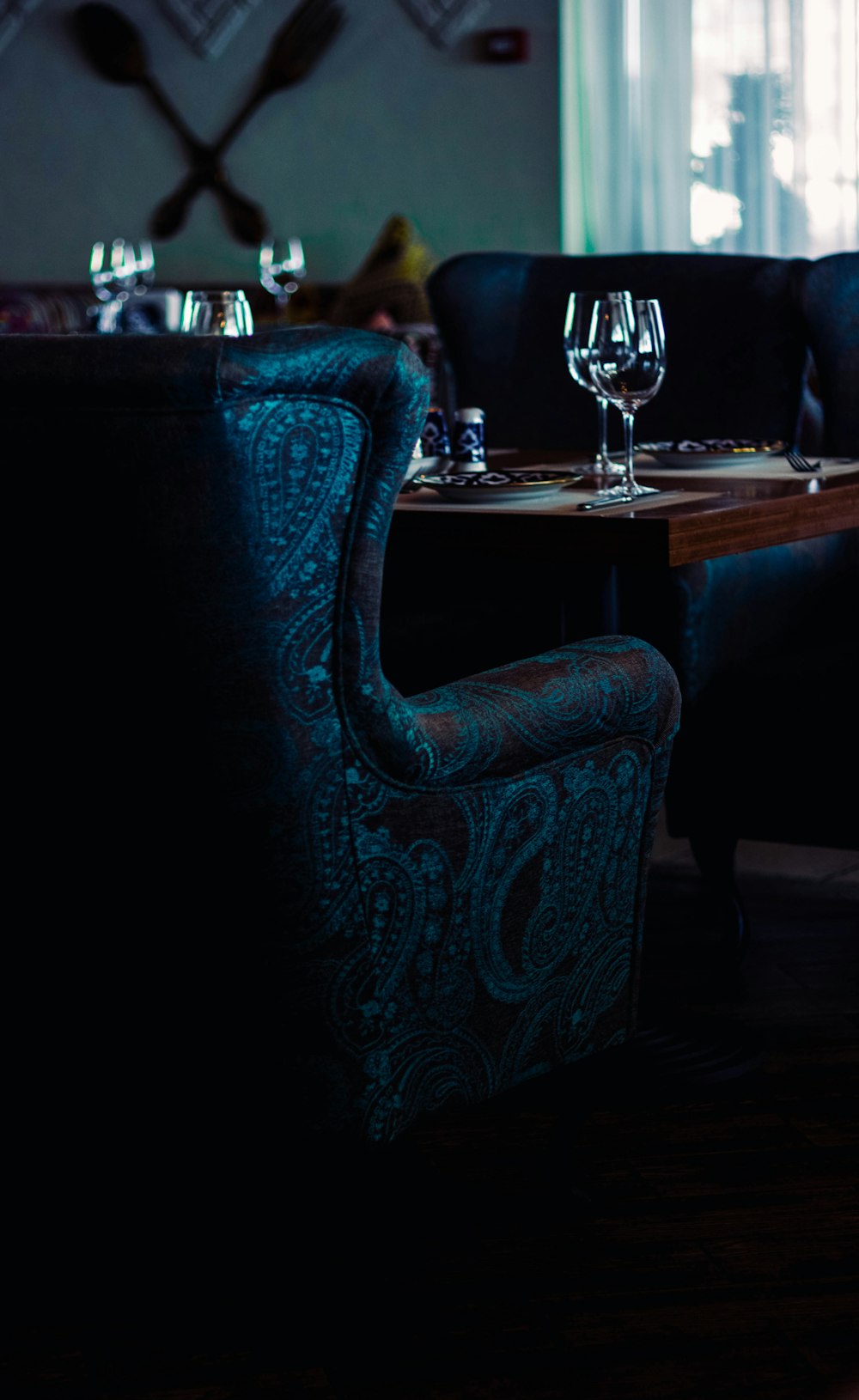 gray and brown paisley chair near brown table