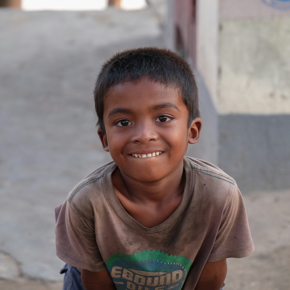 selective focus photography of boy showing his teeth