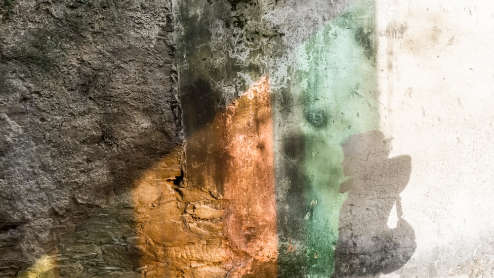 a shadow of a person standing next to a wall