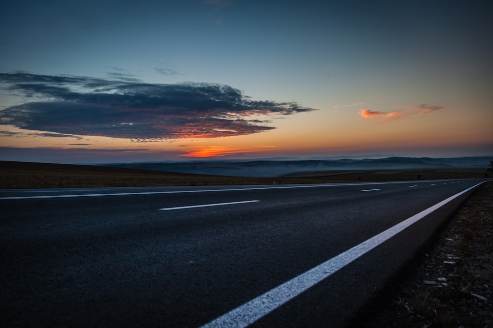 black concrete road during sunset