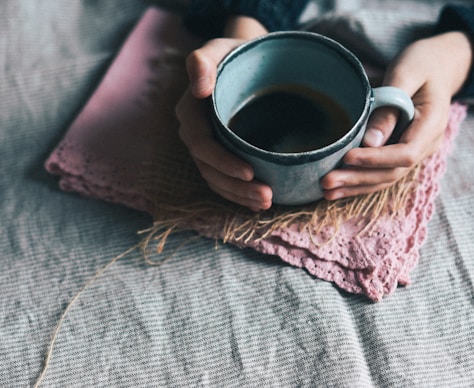 person holding green mug