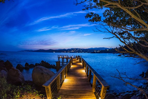 Brown dock with light beside rock formation at daytime — Sayulita, Mexico