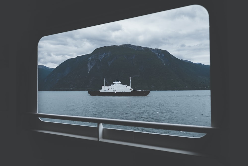 ship on body of water under gray sky during daytime