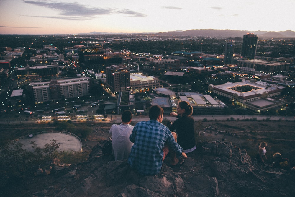 three person on cliff