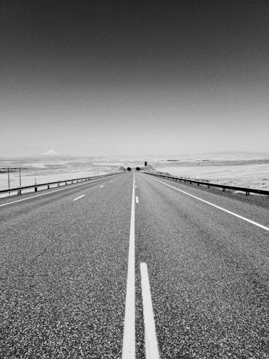 grayscale photo of concrete road