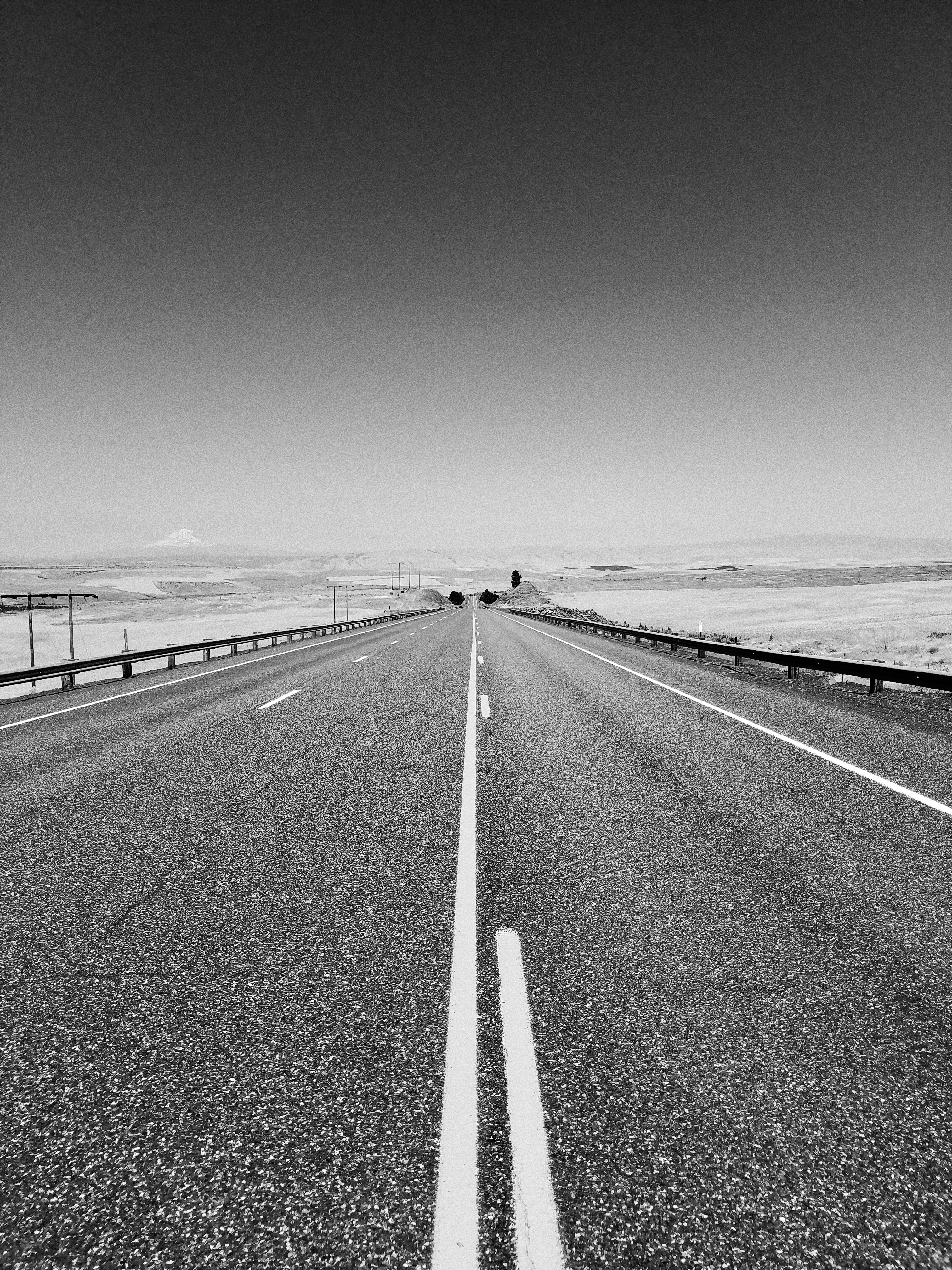 grayscale photo of concrete road