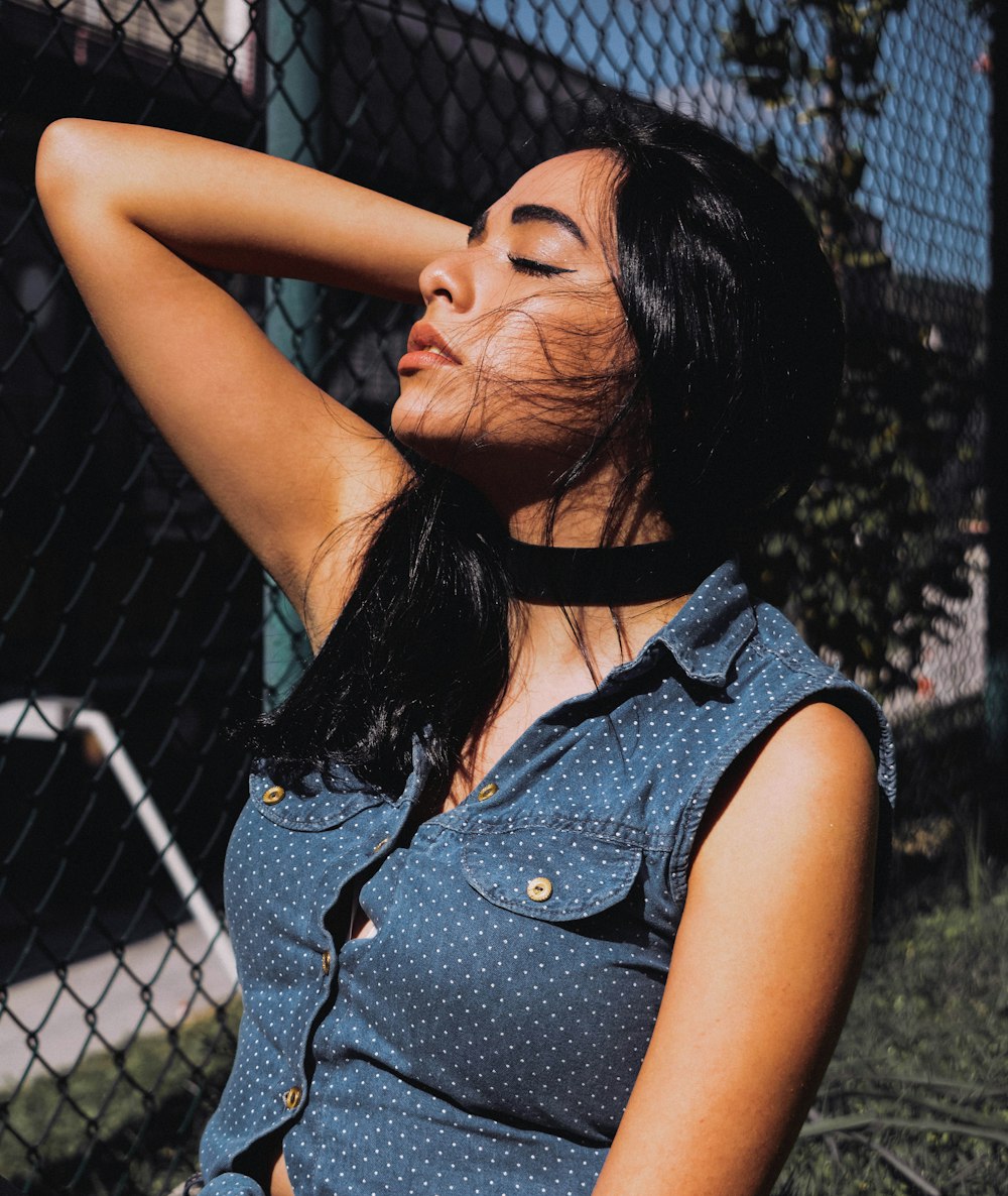 woman looking up while leaning her head on hand