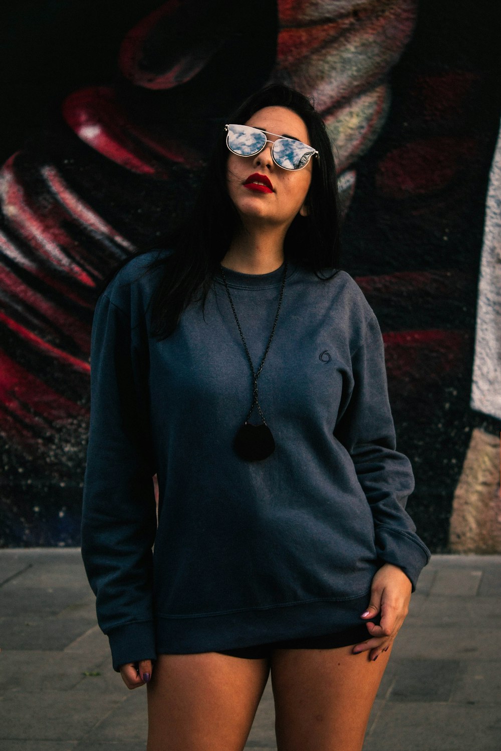woman standing near graffiti wall during daytime