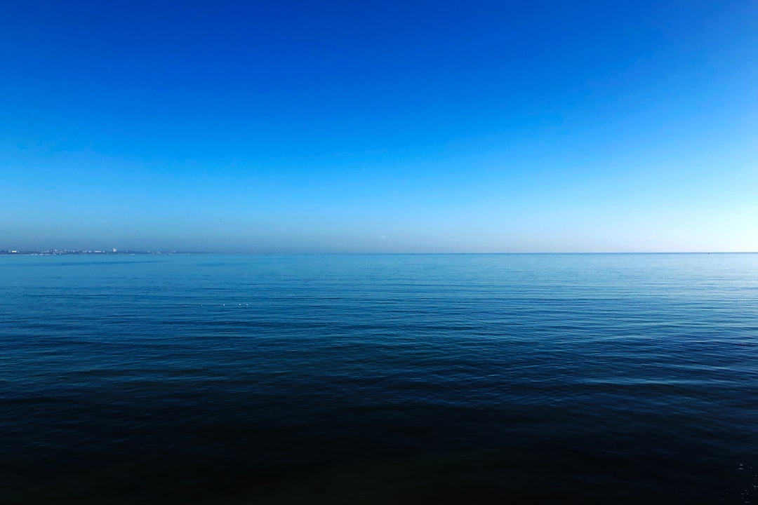 body of water under blue sky