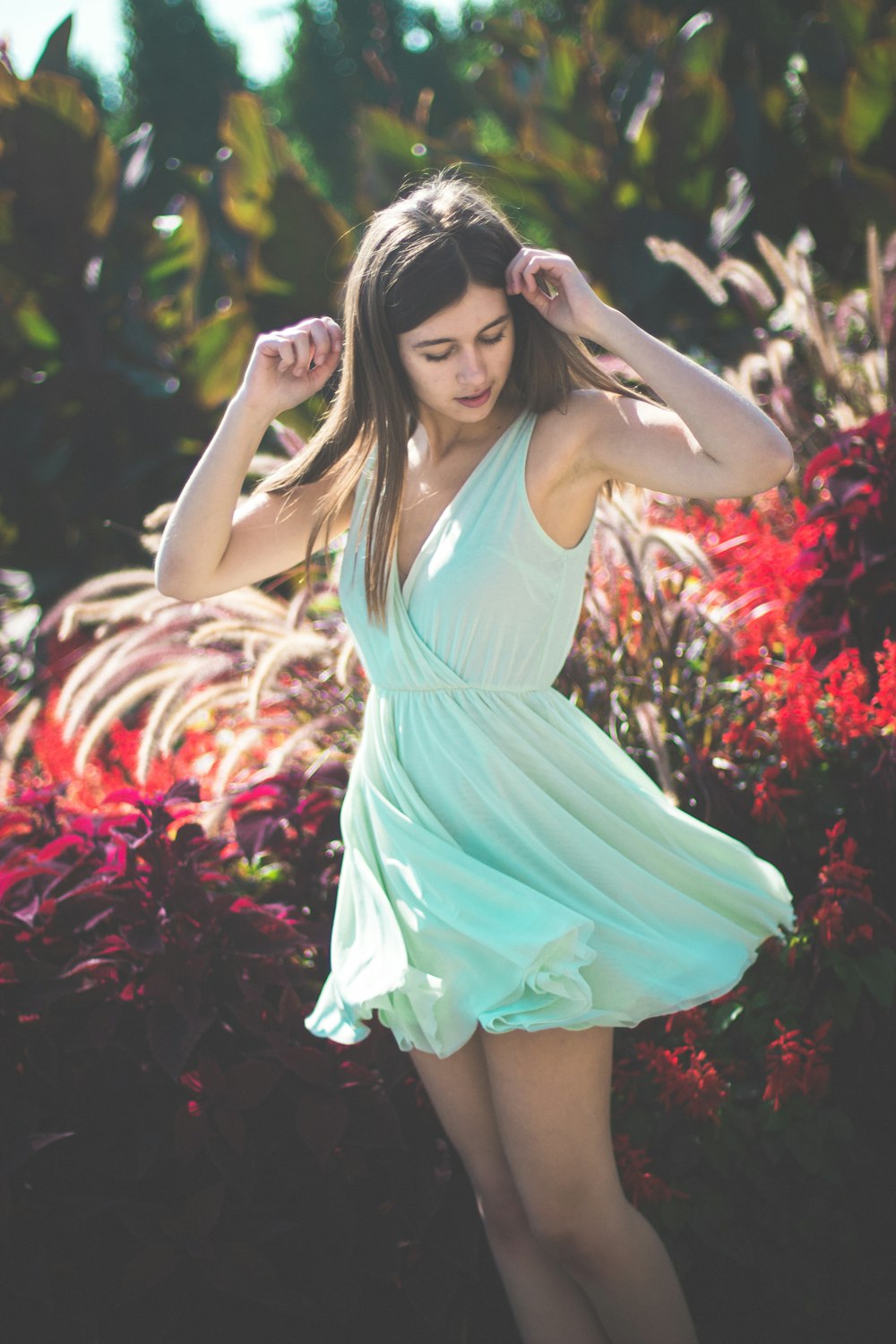 woman standing in front of bushes