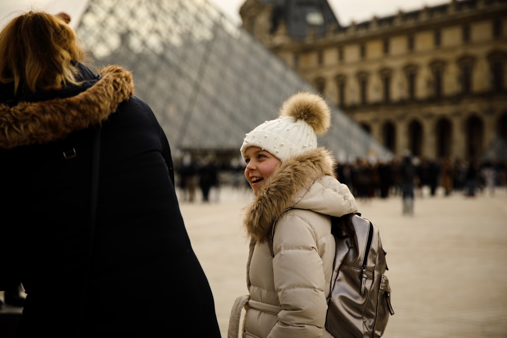 girl wearing coat talking to a woman at Rock & Roll museum