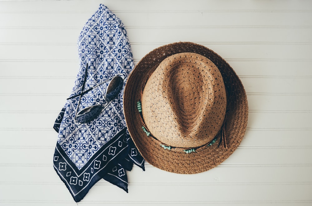 brown hat beside black handkerchief