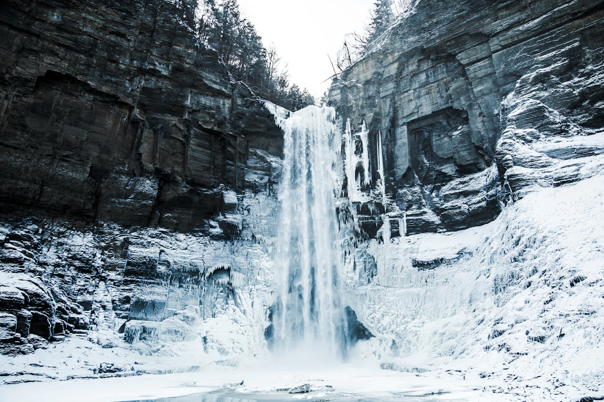 Waterfall in a snow-covered sandstone canyon in winter