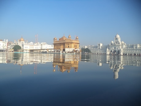 A serene view of Shree Ram Mandir bathed in golden sunlight during early morning.