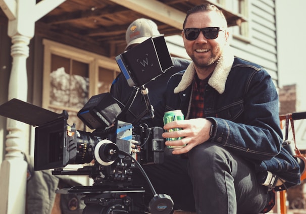 director holding green tin can