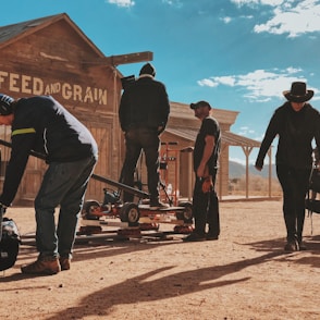 four men standing outside Feed and Grain store