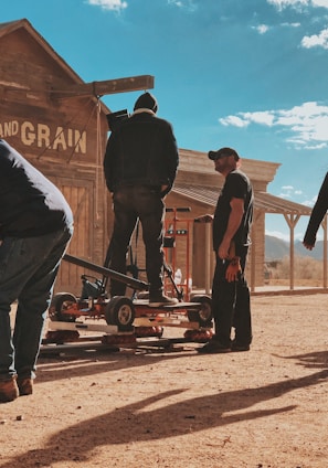 four men standing outside Feed and Grain store