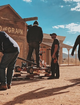 four men standing outside Feed and Grain store