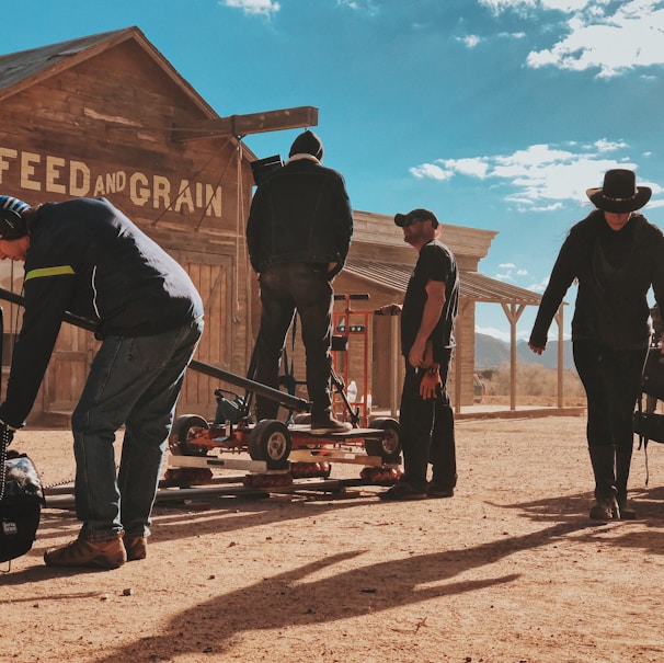 four men standing outside Feed and Grain store