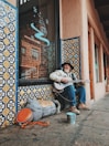 man playing guitar on street
