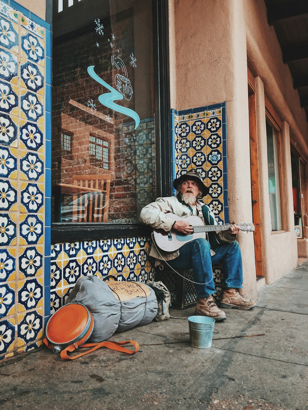 man playing guitar on street