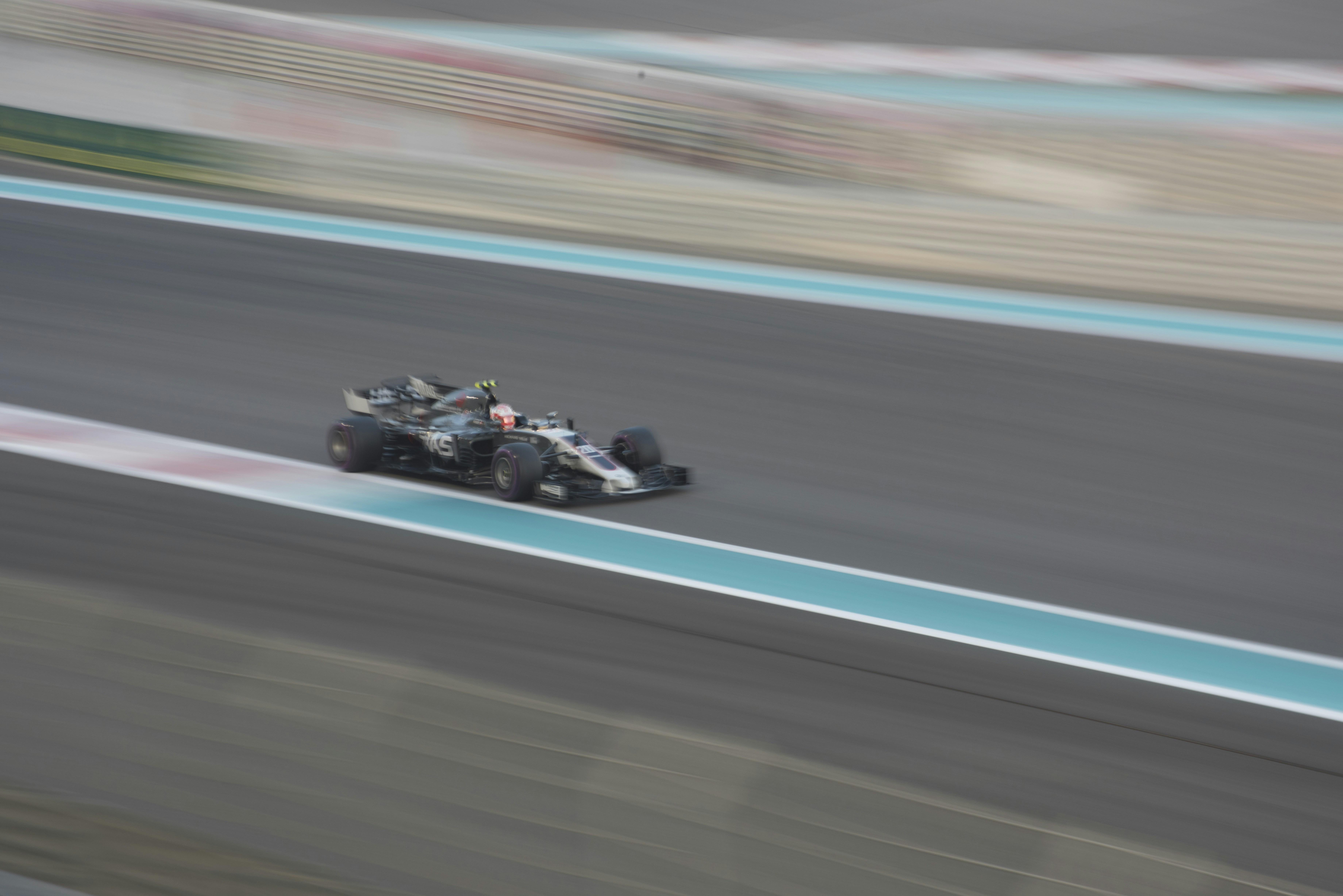 Formula 1 racing car speeding on track with motion blur