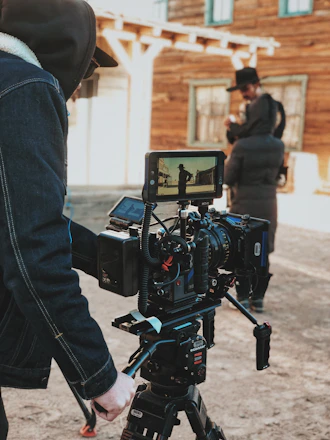 A filmmaker setting up a camera on an indie film set, capturing the essence of storytelling.