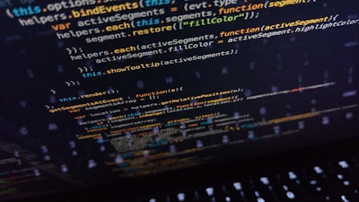 Lines of code displayed on a computer screen, featuring syntax used in programming languages such as JavaScript. The screen shows various functions and variables highlighted in different colors, hinting at coding activity.