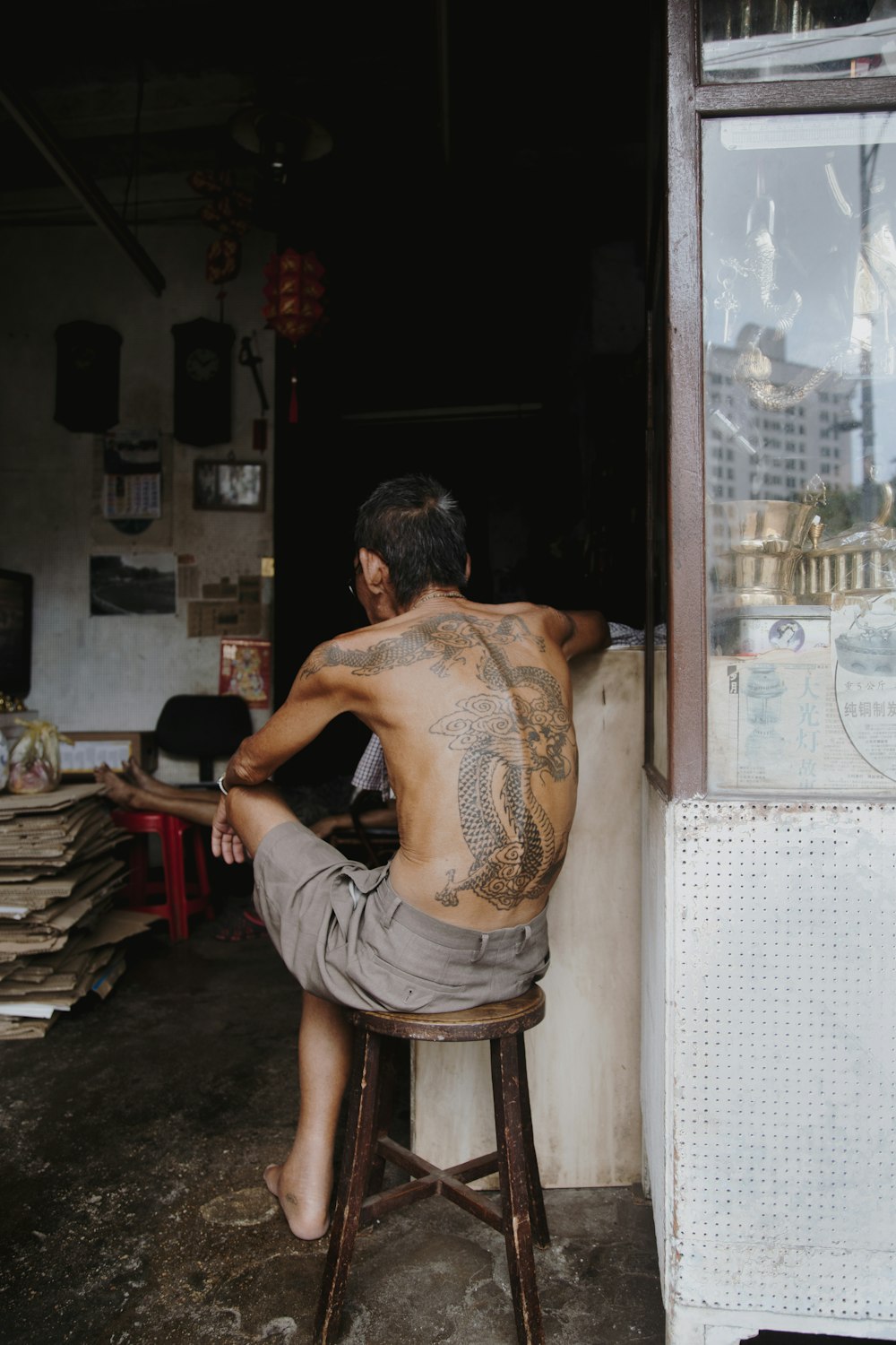 man sitting on wooden stool