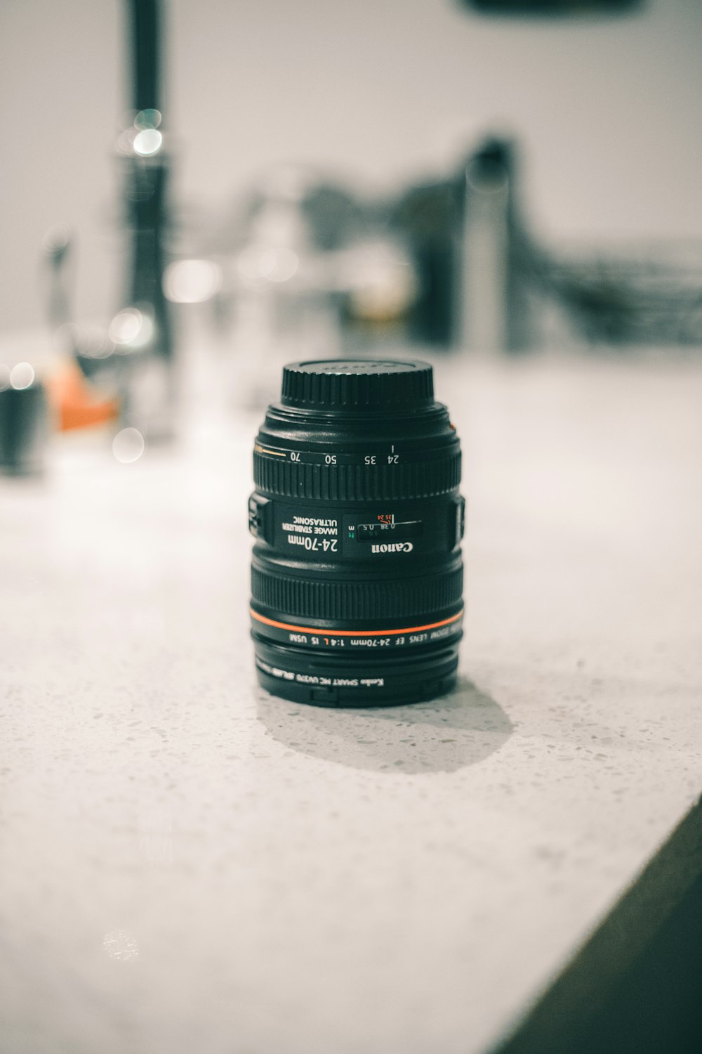 shallow focus photography of camera lens on top of counter