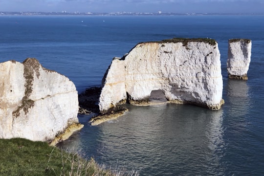 coastal rocks on body of water during daytime in Purbeck Heritage Coast United Kingdom