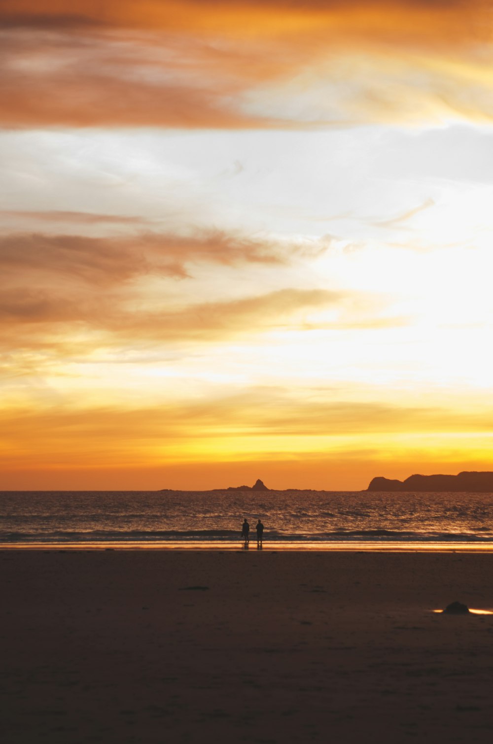 two person standing in front of beach