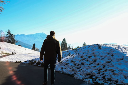 man standing near snow pile in Meggenhorn Castle Switzerland