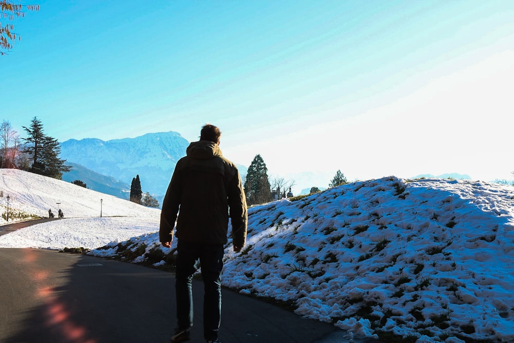 man standing near snow pile